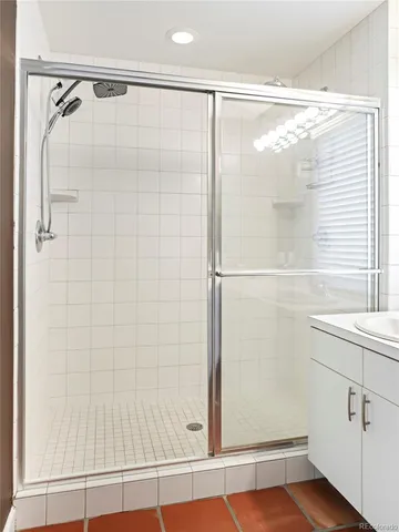 a bathroom with a glass shower door