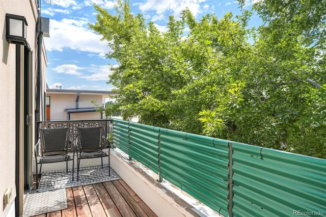 a view of balcony with wooden floor and fence