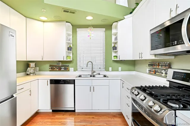 a kitchen with a sink stove top oven and microwave