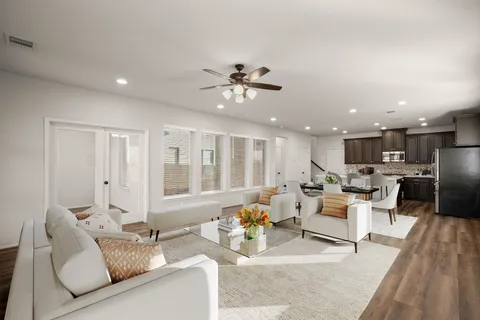 a living room with furniture and wooden floor