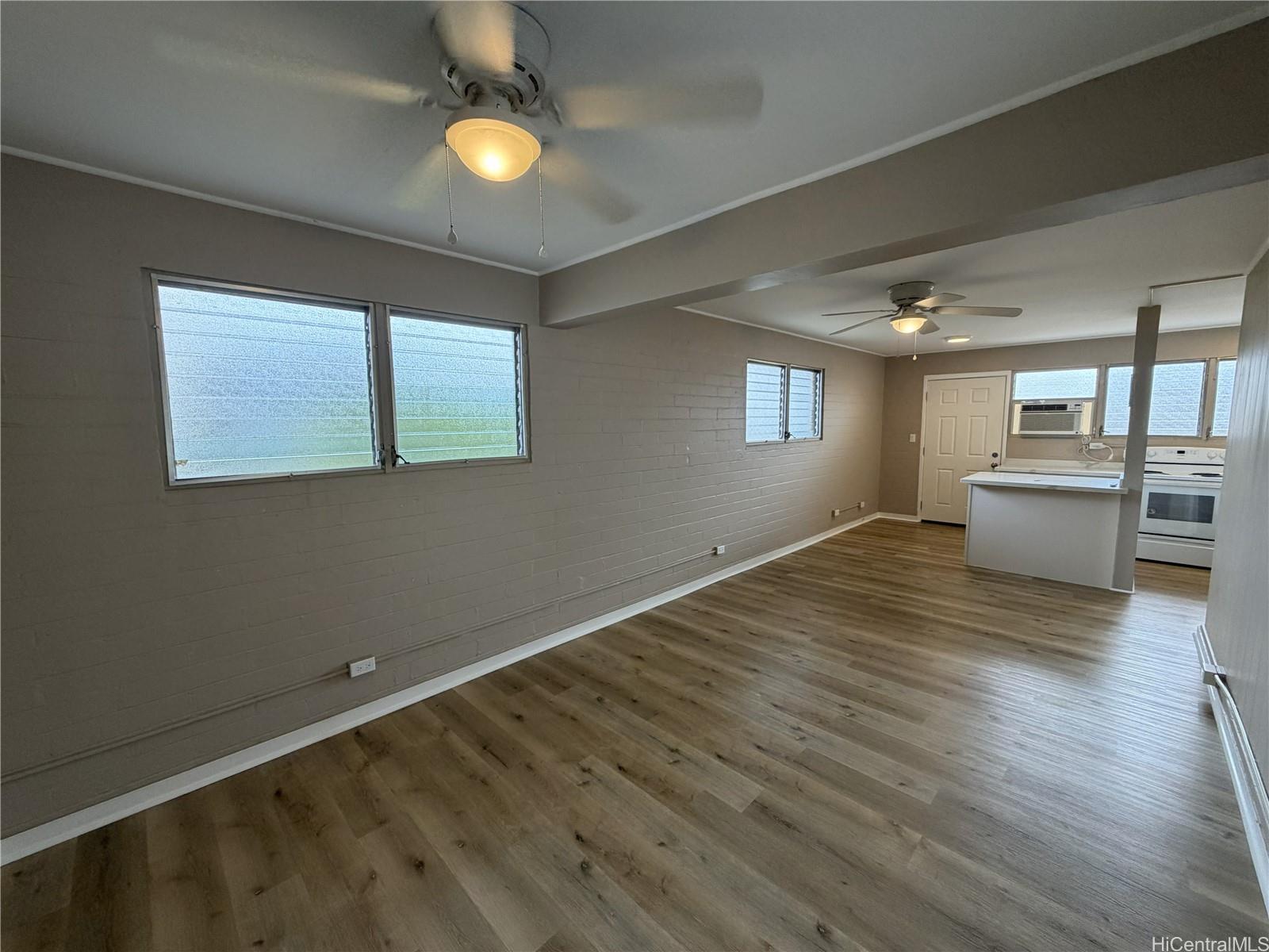 733 Coolidge Street, Unit 207 Honolulu, HI 96826 - Photo 1 of 6 a view of a livingroom with furniture wooden floor and windows