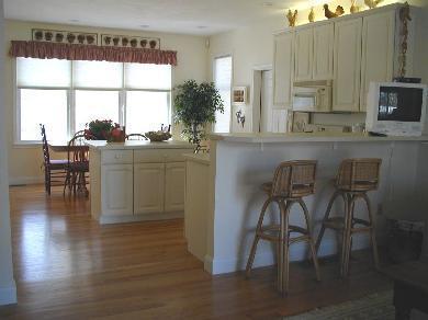 8 Finway Mashpee, MA 02649 - Photo 4 of 35 a kitchen with stainless steel appliances granite countertop wooden floor a dining table and chairs