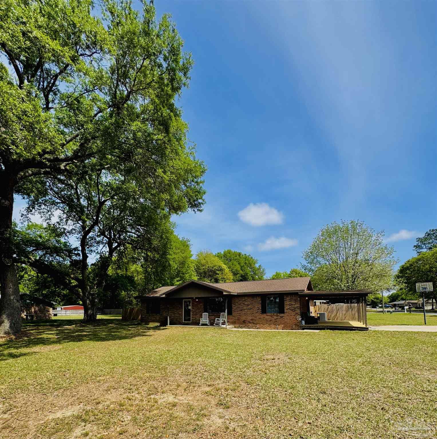 4400 Mundy Lane Pace, FL 32571 - Photo 1 of 23 a view of a swimming pool with an outdoor seating and a yard