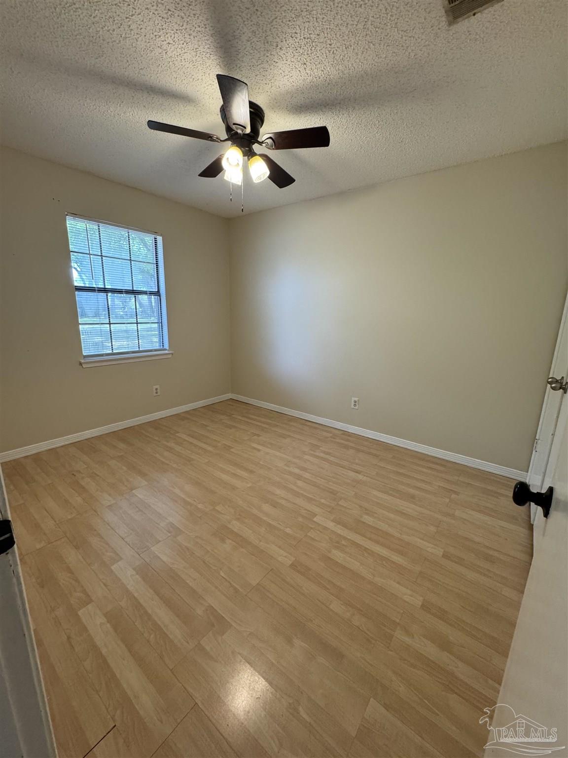 4400 Mundy Lane Pace, FL 32571 - Photo 12 of 23 an empty room with windows and fan