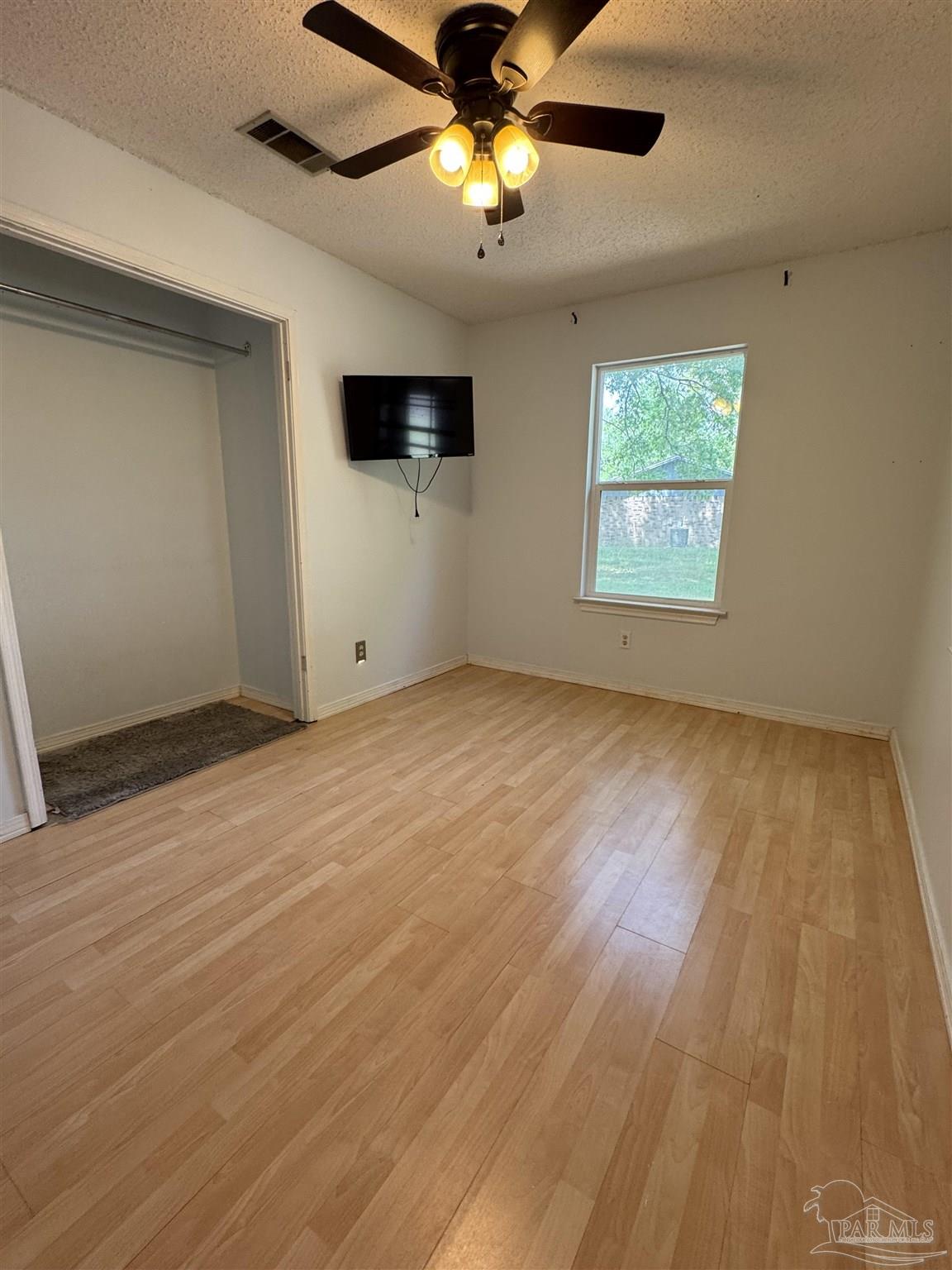 4400 Mundy Lane Pace, FL 32571 - Photo 14 of 23 a view of empty room with wooden floor and fan