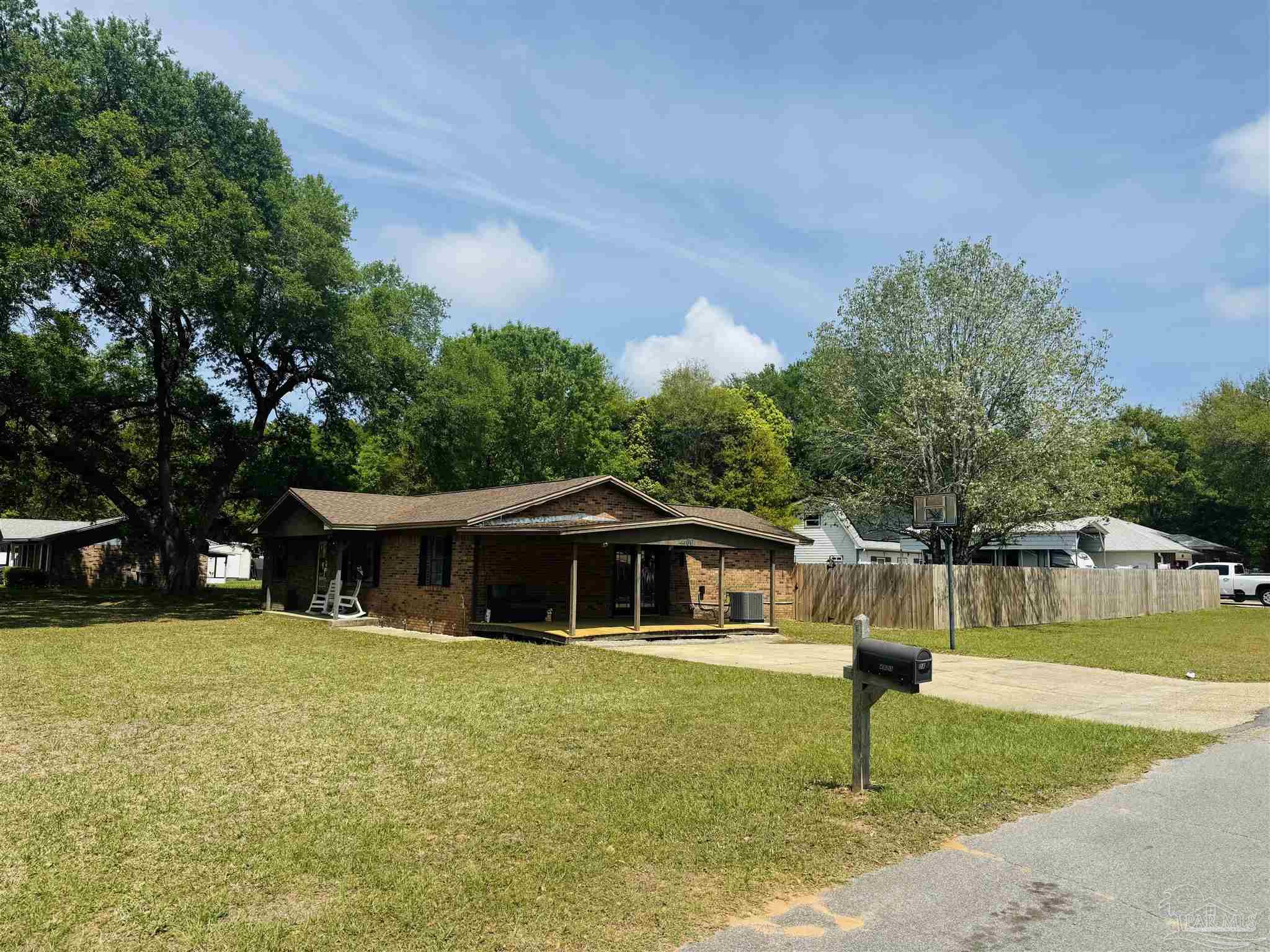 4400 Mundy Lane Pace, FL 32571 - Photo 20 of 23 a front view of a house with a yard