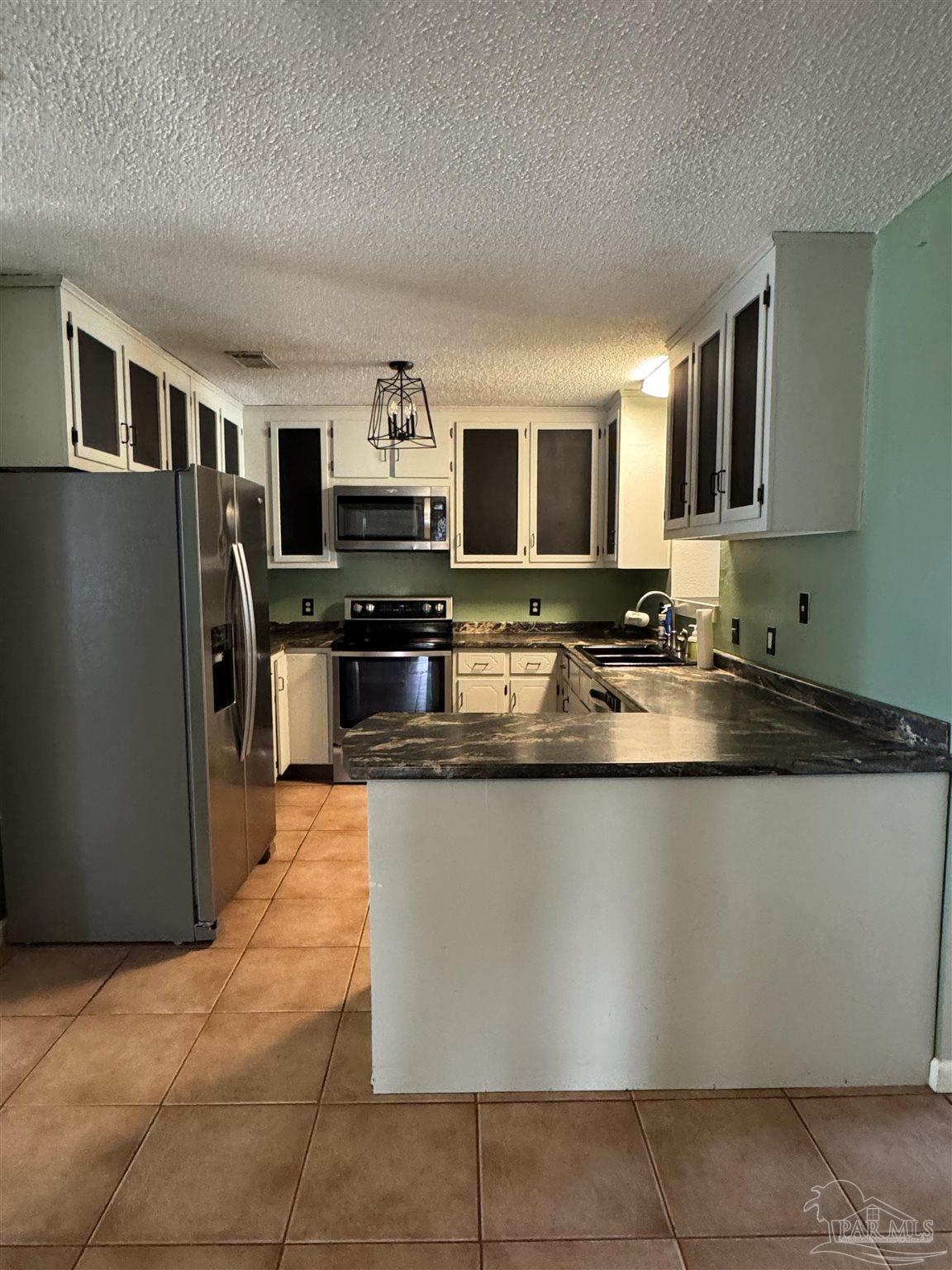 4400 Mundy Lane Pace, FL 32571 - Photo 2 of 23 a kitchen with stainless steel appliances granite countertop a refrigerator a stove a sink a microwave and a refrigerator