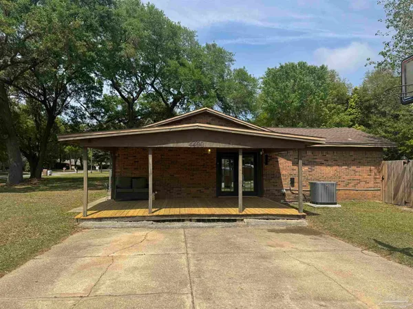 a view of a house with a backyard and a tree