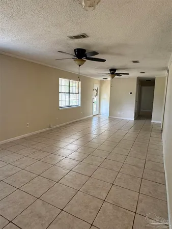 an empty room with windows and cabinet