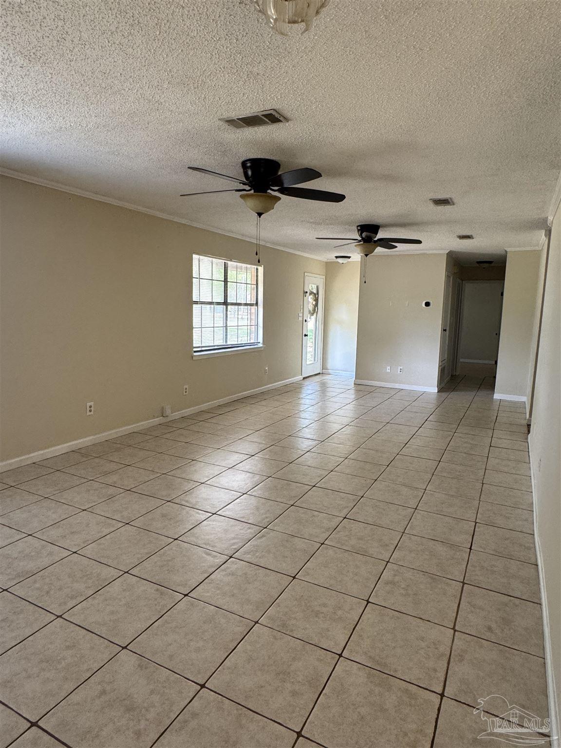4400 Mundy Lane Pace, FL 32571 - Photo 6 of 23 an empty room with windows and cabinet