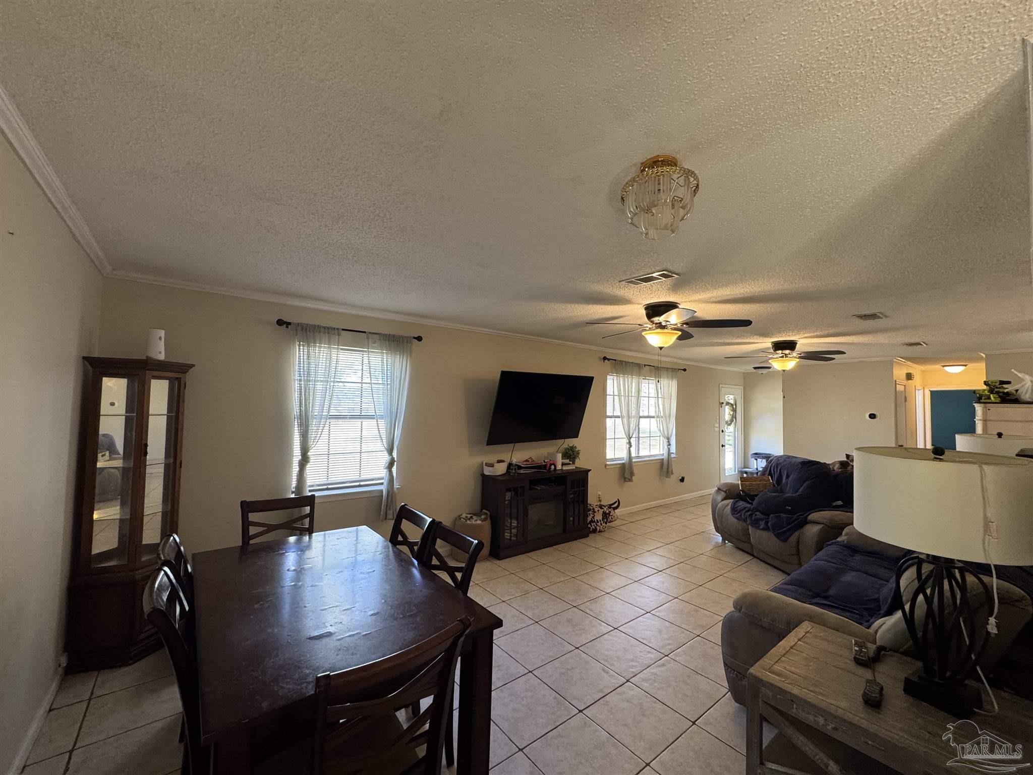 4400 Mundy Lane Pace, FL 32571 - Photo 7 of 23 a living room with furniture and a flat screen tv