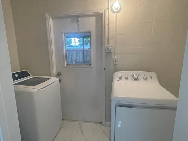 a utility room with dryer and washer