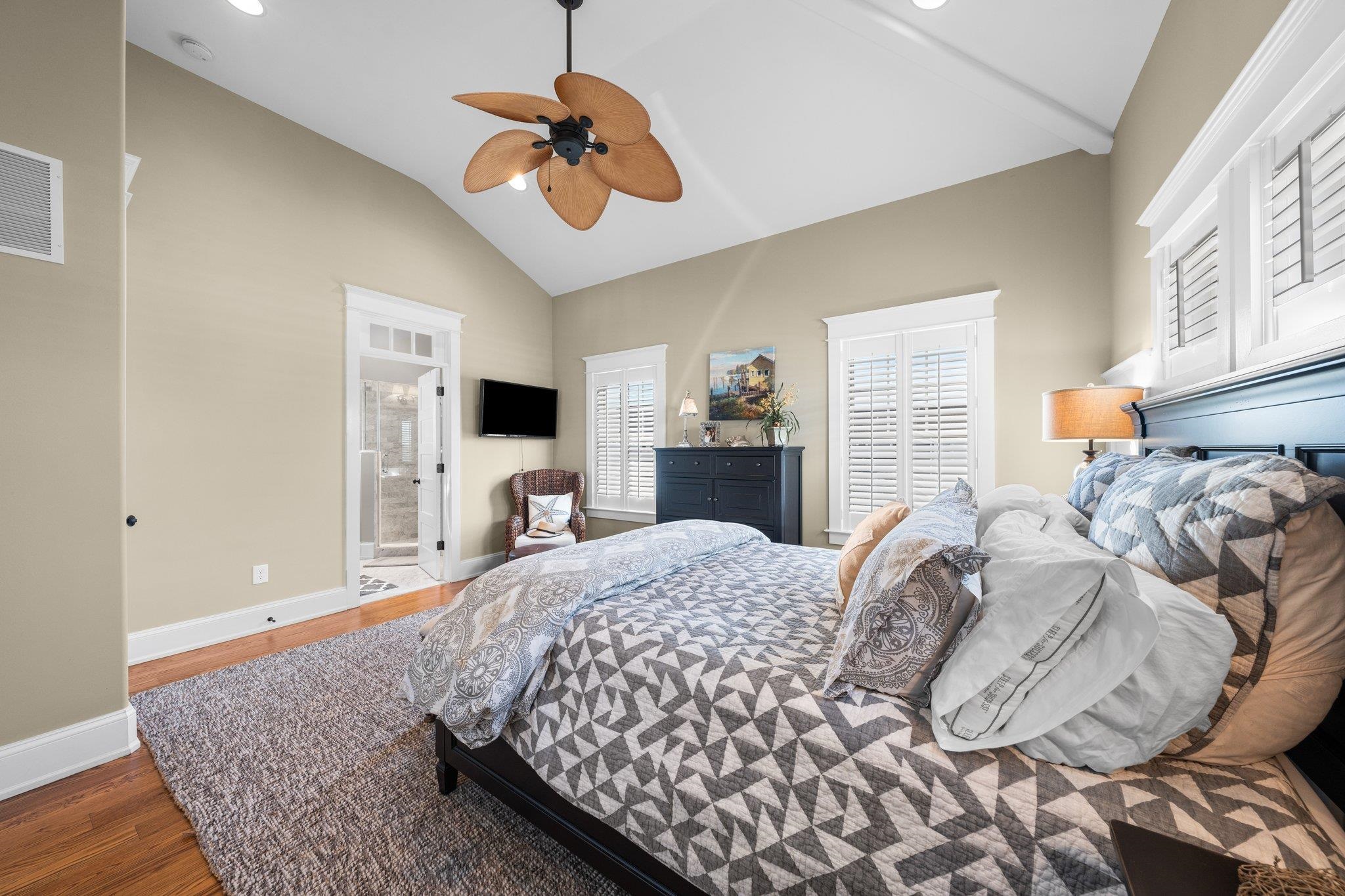 243 110th Street Stone Harbor, NJ 08247 - Photo 17 of 34 a bedroom with a bed chandelier and a window