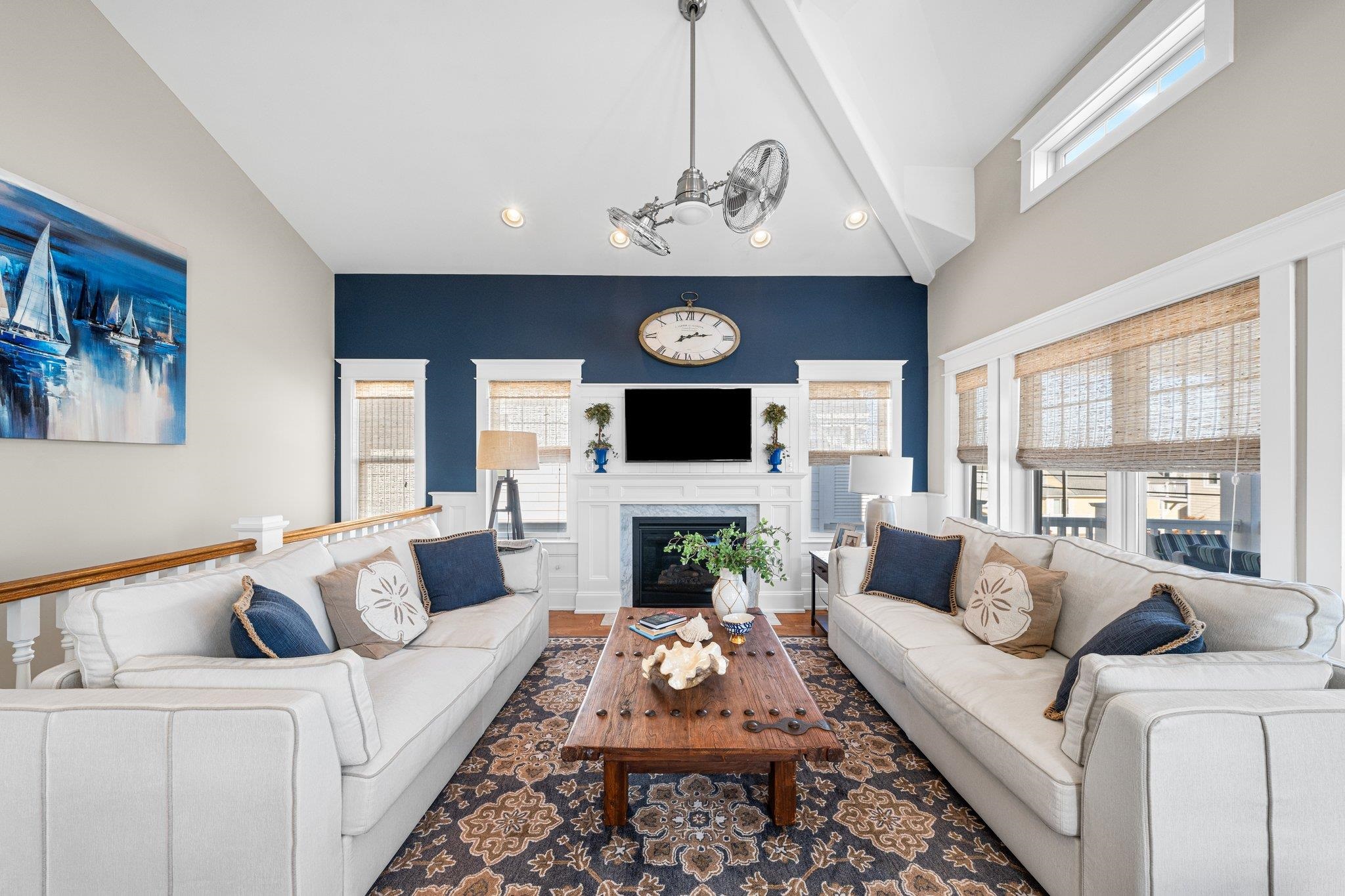 243 110th Street Stone Harbor, NJ 08247 - Photo 25 of 34 a living room with furniture a fireplace and a flat tv screen