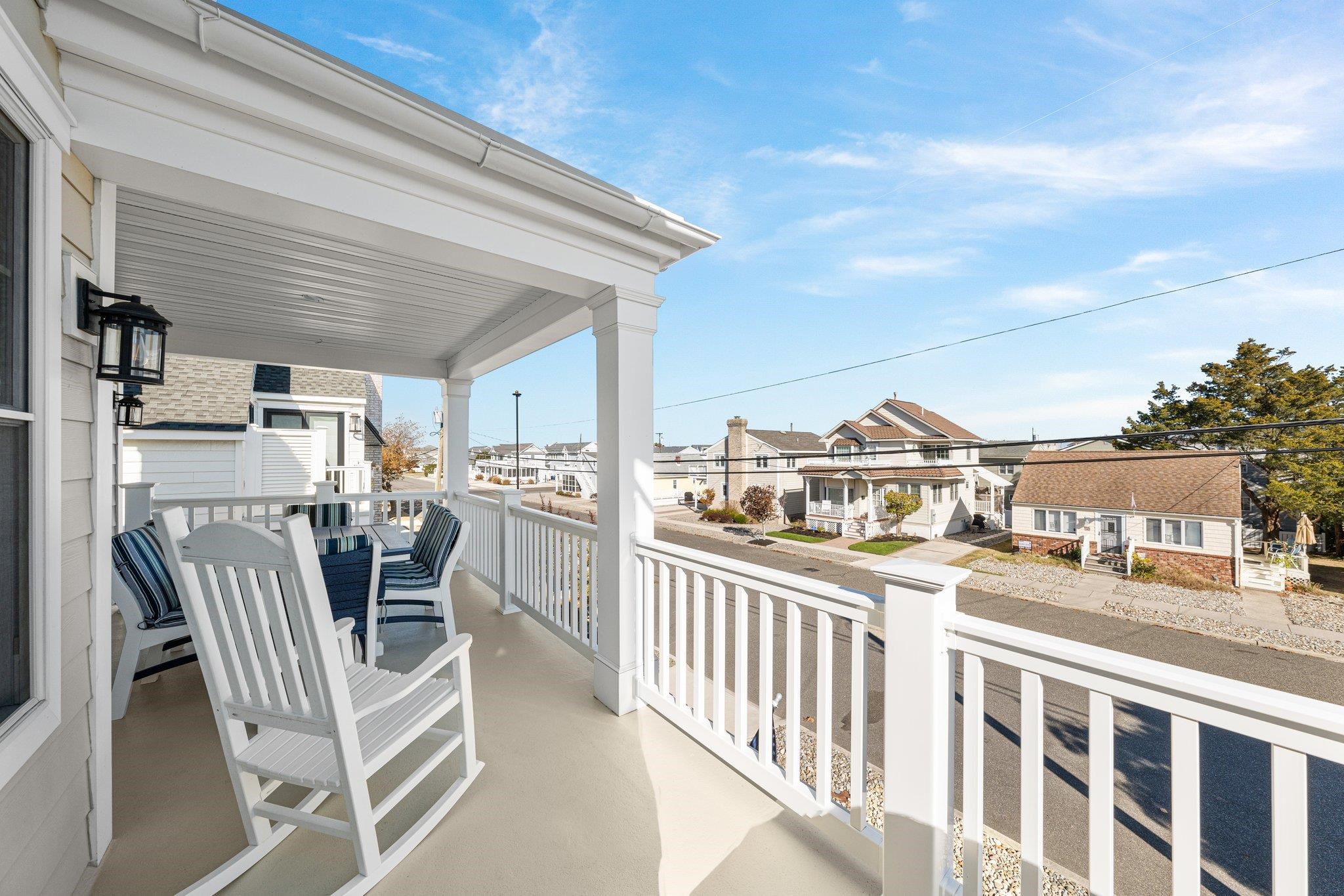 243 110th Street Stone Harbor, NJ 08247 - Photo 28 of 34 a view of a balcony dining table and chairs