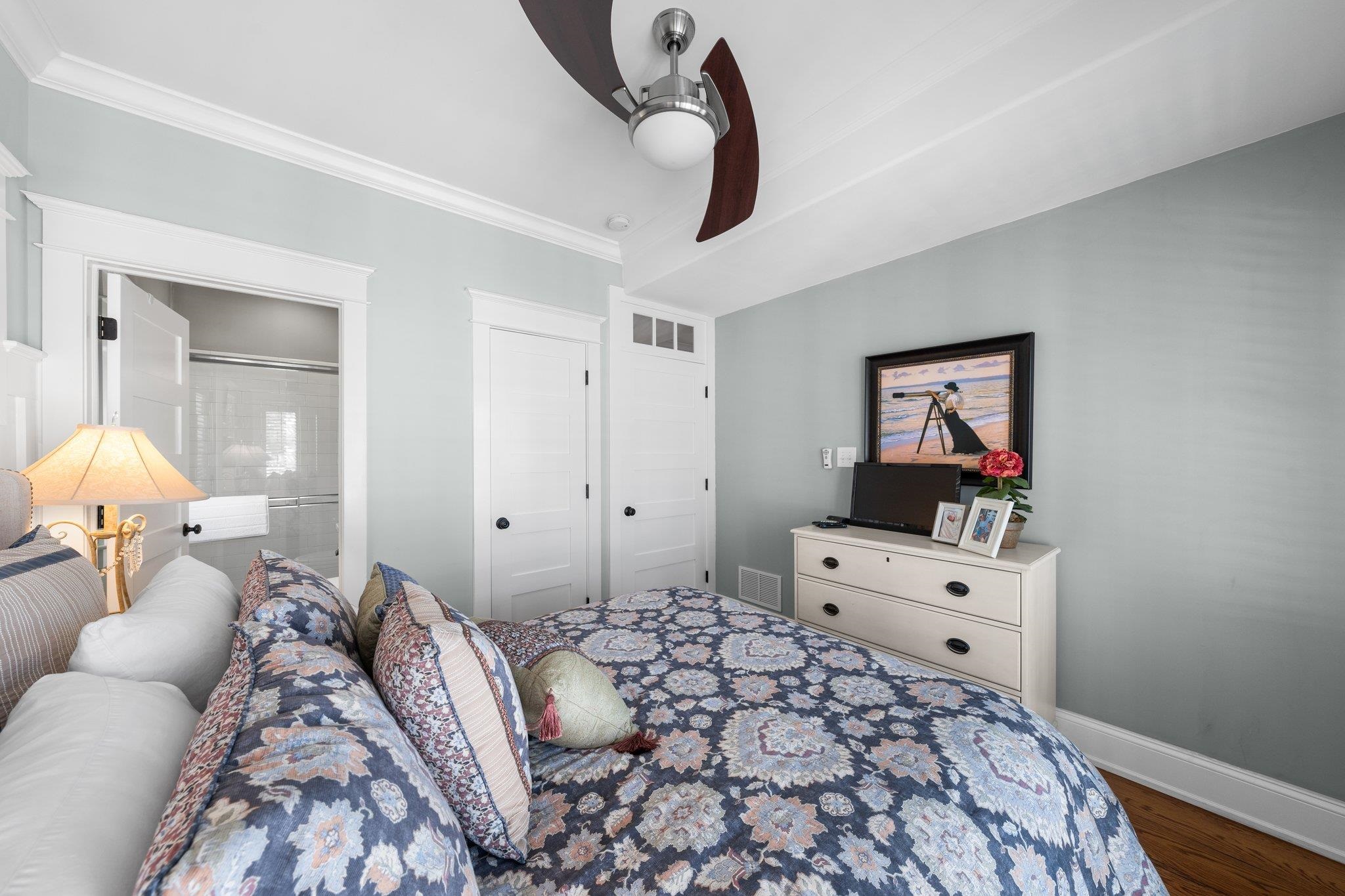 243 110th Street Stone Harbor, NJ 08247 - Photo 5 of 34 a bedroom with a bed and a chandelier
