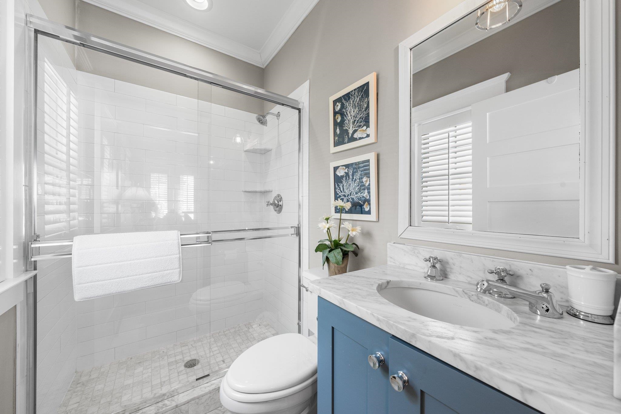 243 110th Street Stone Harbor, NJ 08247 - Photo 6 of 34 a bathroom with a granite countertop sink a toilet a mirror and shower