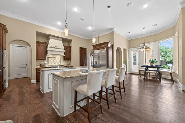 a kitchen with stainless steel appliances granite countertop a stove a refrigerator and a cabinets