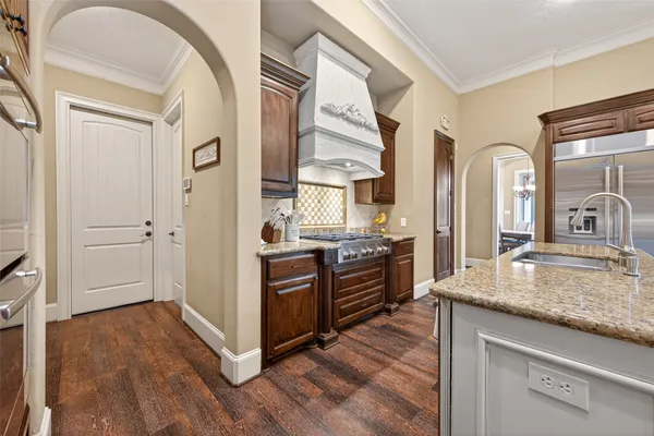 a large kitchen with kitchen island a large island in the center and stainless steel appliances