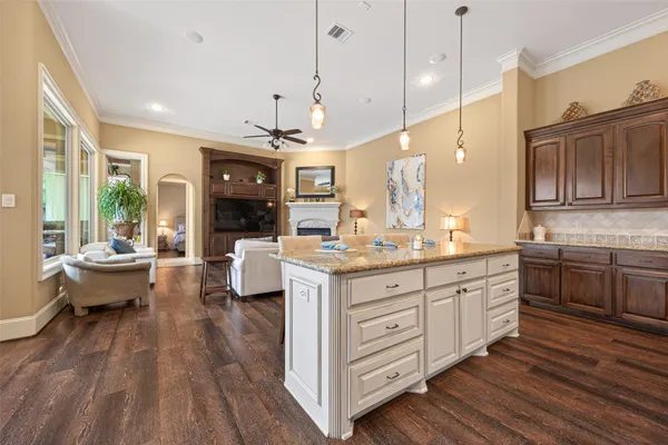 a large kitchen with lots of counter space dining table and stainless steel appliances