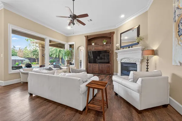 a living room with fireplace furniture and a large window