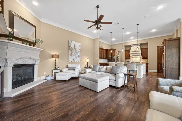 a living room with furniture and a large window with wooden floor