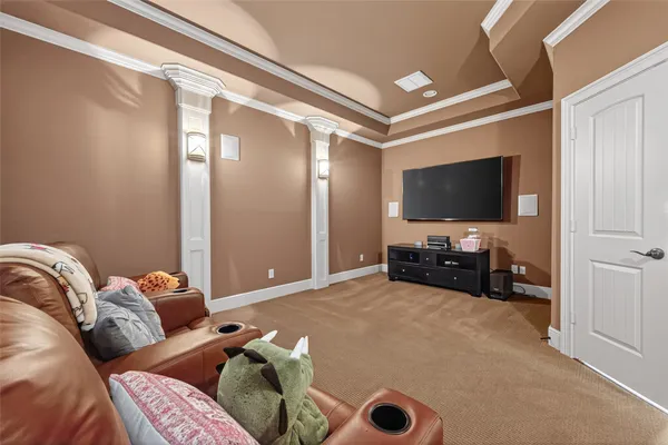 a spacious bedroom with a bed and a chandelier