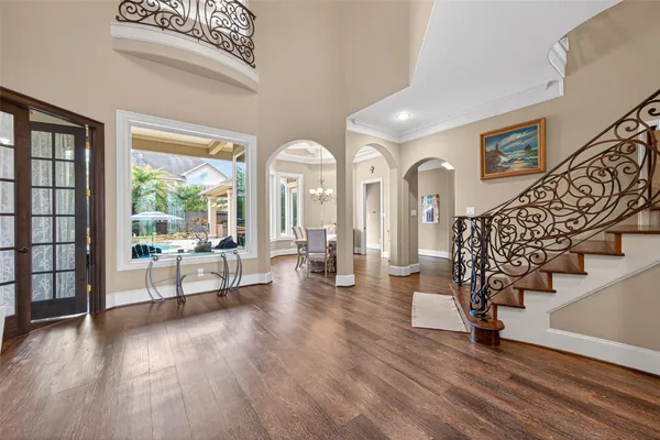 a view of a dining room with furniture wooden floor and chandelier