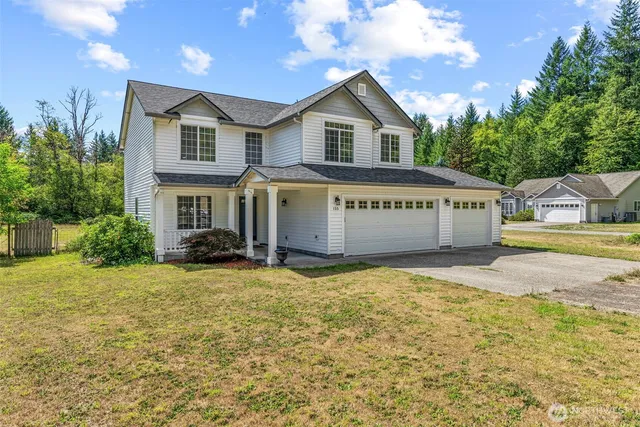 a view of a house with backyard and tree s