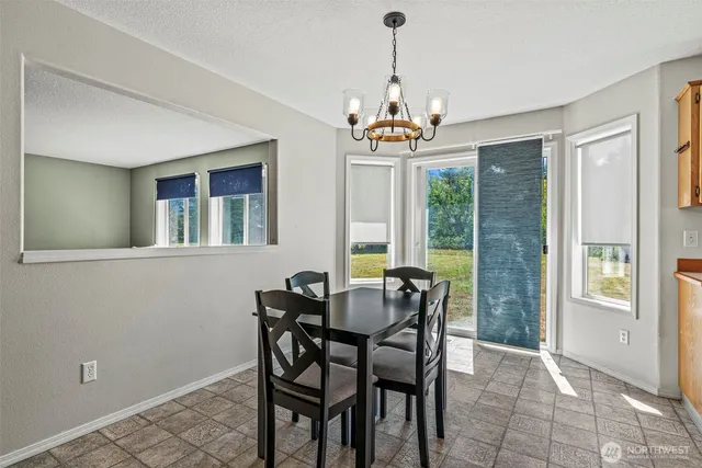 a view of a dining room with furniture window and outside view