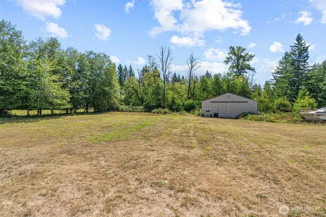 a view of a field with trees in the background