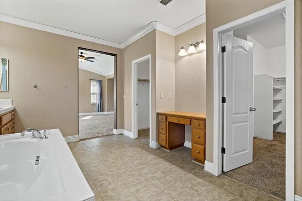 a en suite bathroom with a sink and a mirror