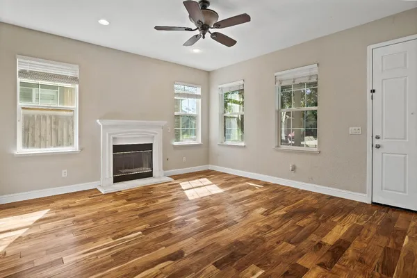 a view of empty room with fireplace and windows