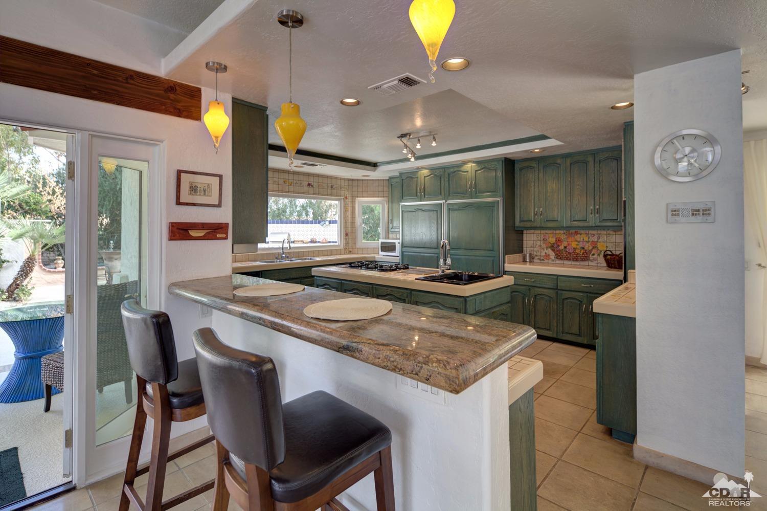 2 Vista Santa Rosa Rancho Mirage, CA 92270 - Photo 28 of 60 a kitchen with a stove and a refrigerator