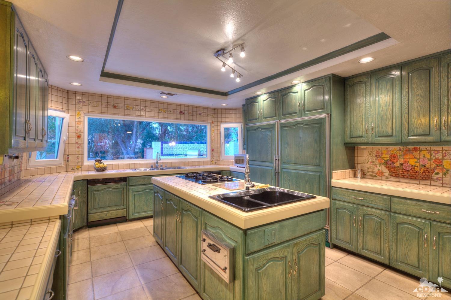2 Vista Santa Rosa Rancho Mirage, CA 92270 - Photo 30 of 60 a kitchen with a sink stove and cabinets