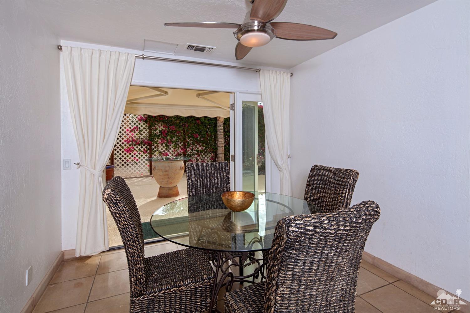 2 Vista Santa Rosa Rancho Mirage, CA 92270 - Photo 31 of 60 a view of a dining room with furniture and wooden floor