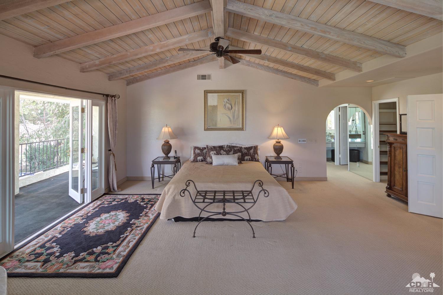 2 Vista Santa Rosa Rancho Mirage, CA 92270 - Photo 34 of 60 a spacious bedroom with a bed mirror and window
