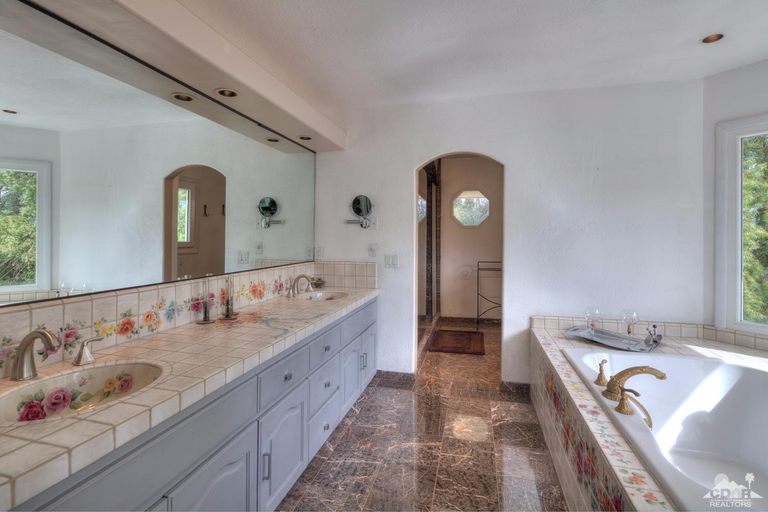 2 Vista Santa Rosa Rancho Mirage, CA 92270 - Photo 36 of 60 a spacious bathroom with a double vanity sink and a mirror