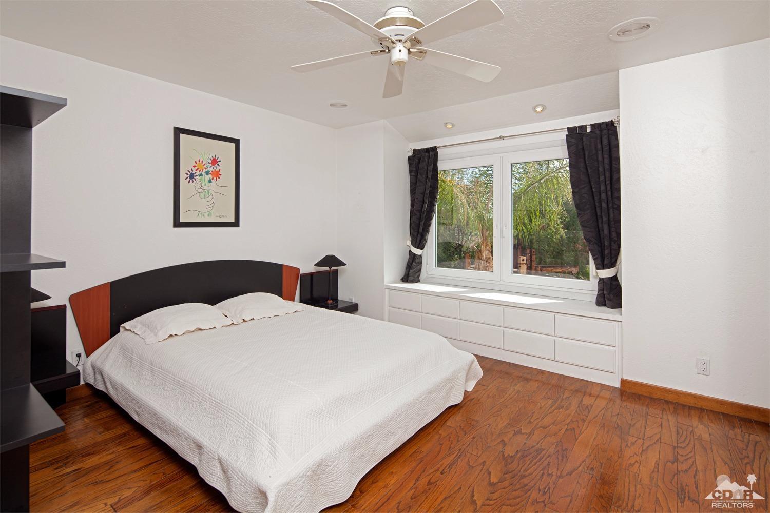2 Vista Santa Rosa Rancho Mirage, CA 92270 - Photo 38 of 60 a spacious bedroom with a bed and a large window