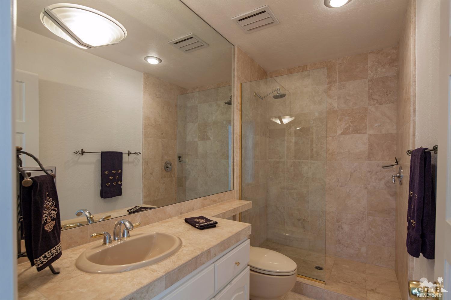 2 Vista Santa Rosa Rancho Mirage, CA 92270 - Photo 39 of 60 a bathroom with a sink toilet a mirror and shower