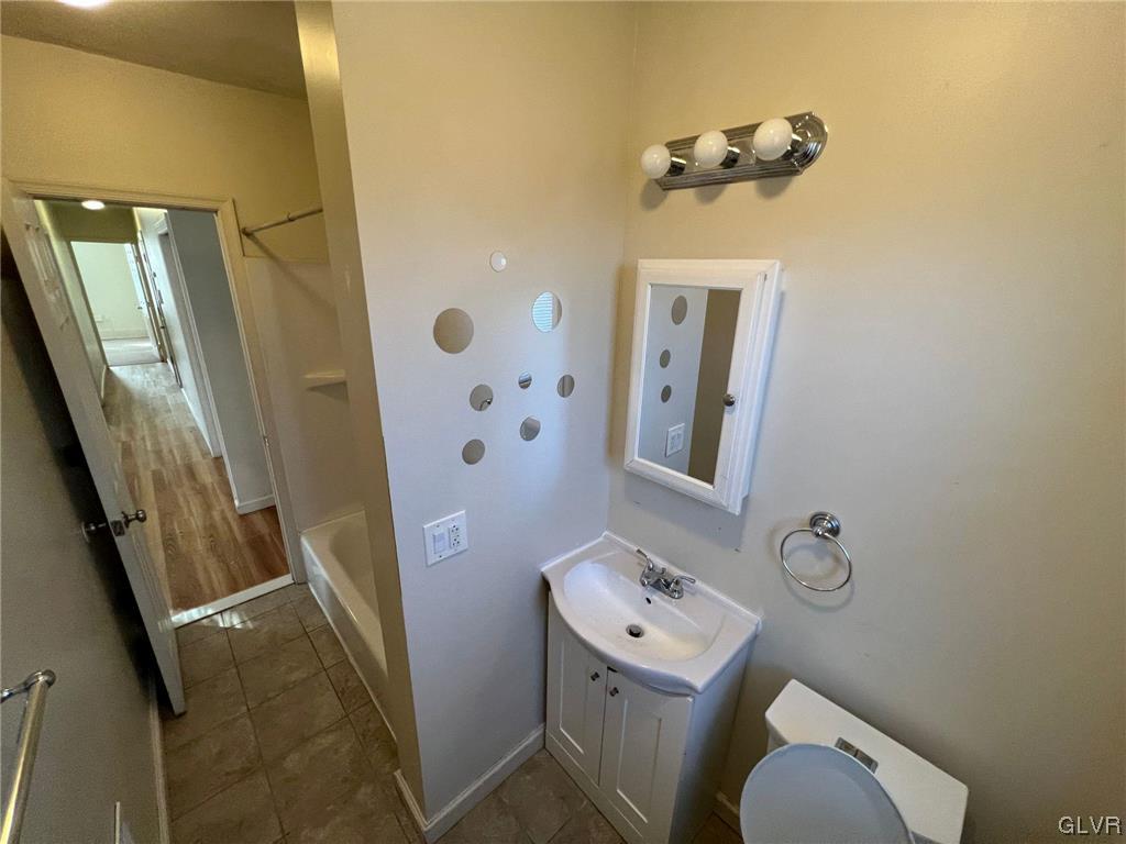 739 East 7th Street, Unit 2 Bethlehem, PA 18015 - Photo 10 of 11 a bathroom with a toilet sink and mirror