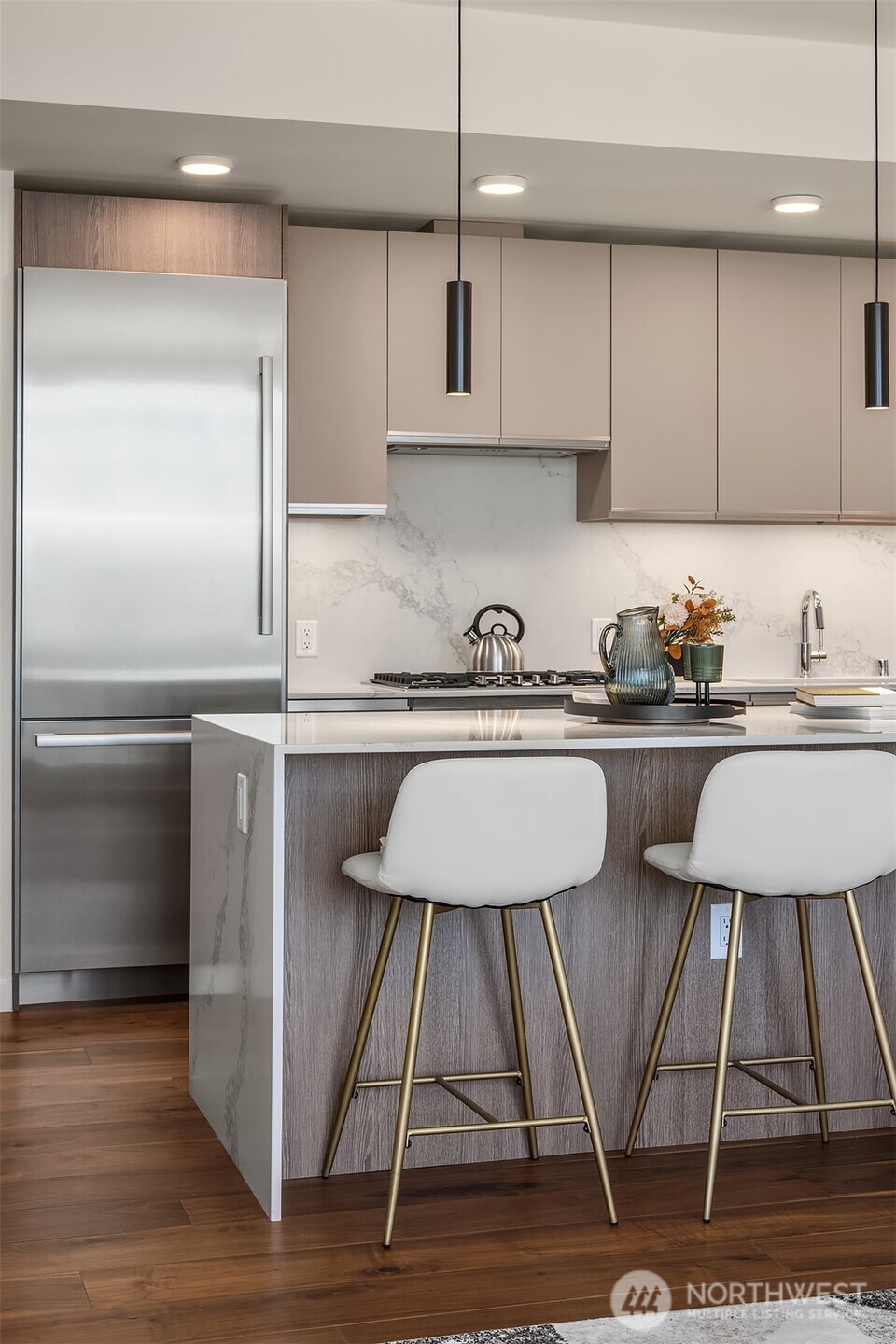 800 Columbia Street, Unit 2505 Seattle, WA 98104 - Photo 11 of 40 a kitchen with a sink cabinets and stainless steel appliances