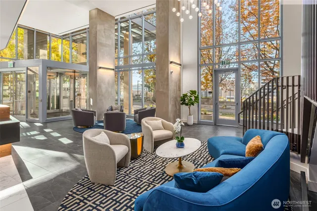 a living room with furniture and a floor to ceiling window
