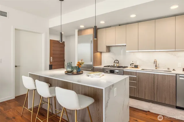 a kitchen with a stove a sink a table and chairs