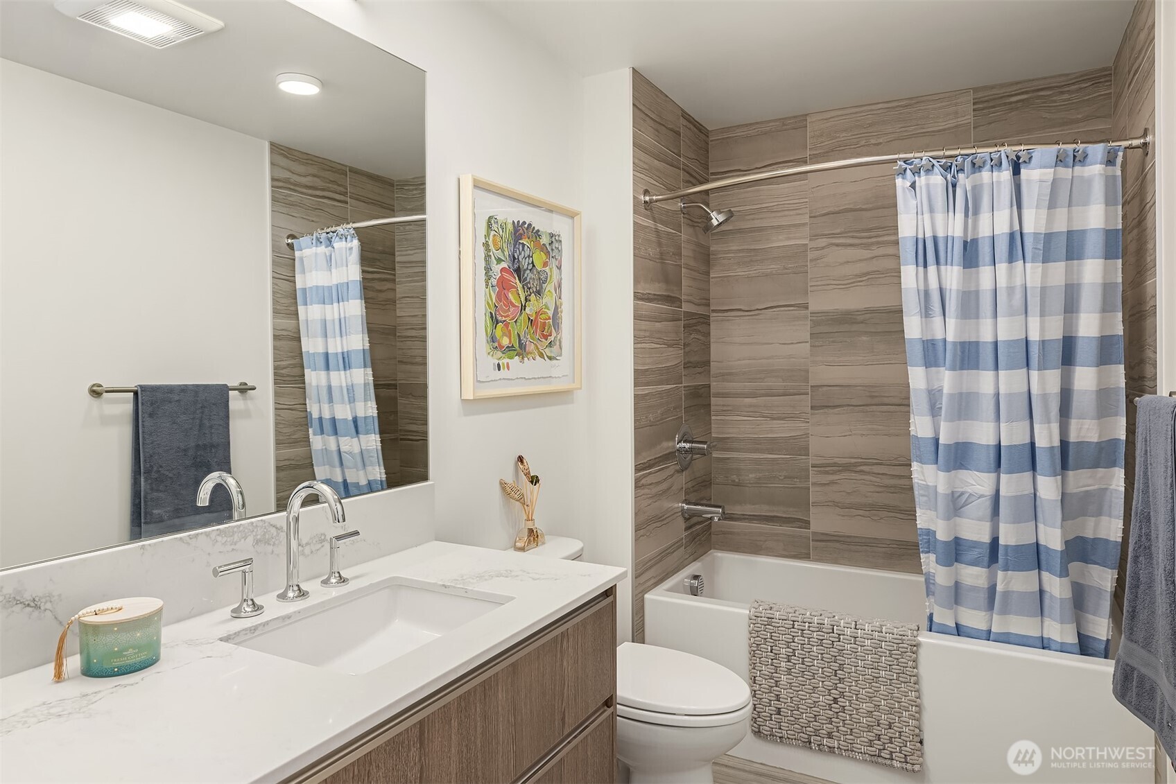 800 Columbia Street, Unit 2505 Seattle, WA 98104 - Photo 8 of 40 a bathroom with a bathtub shower sink vanity mirror and toilet