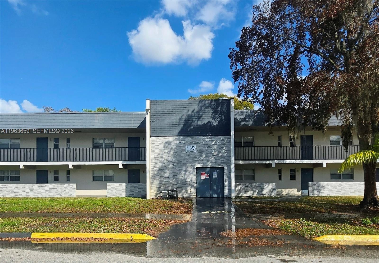 7925 Fairview Drive, Unit 206 Tamarac, FL 33321 - Photo 1 of 21 front view of house with a yard
