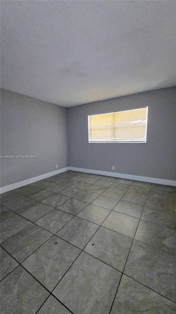 7925 Fairview Drive, Unit 206 Tamarac, FL 33321 - Photo 12 of 21 a view of an empty room with a window