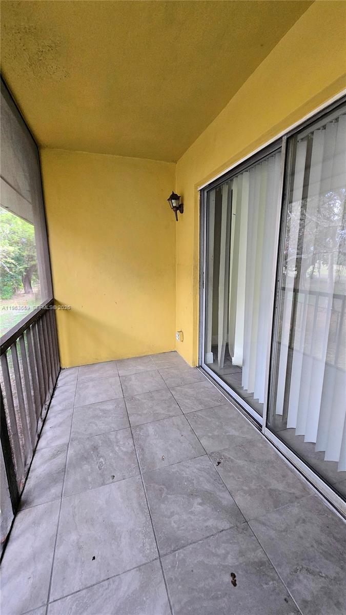 7925 Fairview Drive, Unit 206 Tamarac, FL 33321 - Photo 15 of 21 a view of porch with wooden floor