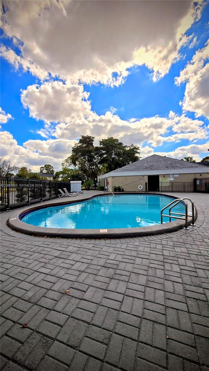7925 Fairview Drive, Unit 206 Tamarac, FL 33321 - Photo 19 of 21 a view of a yard with an umbrella