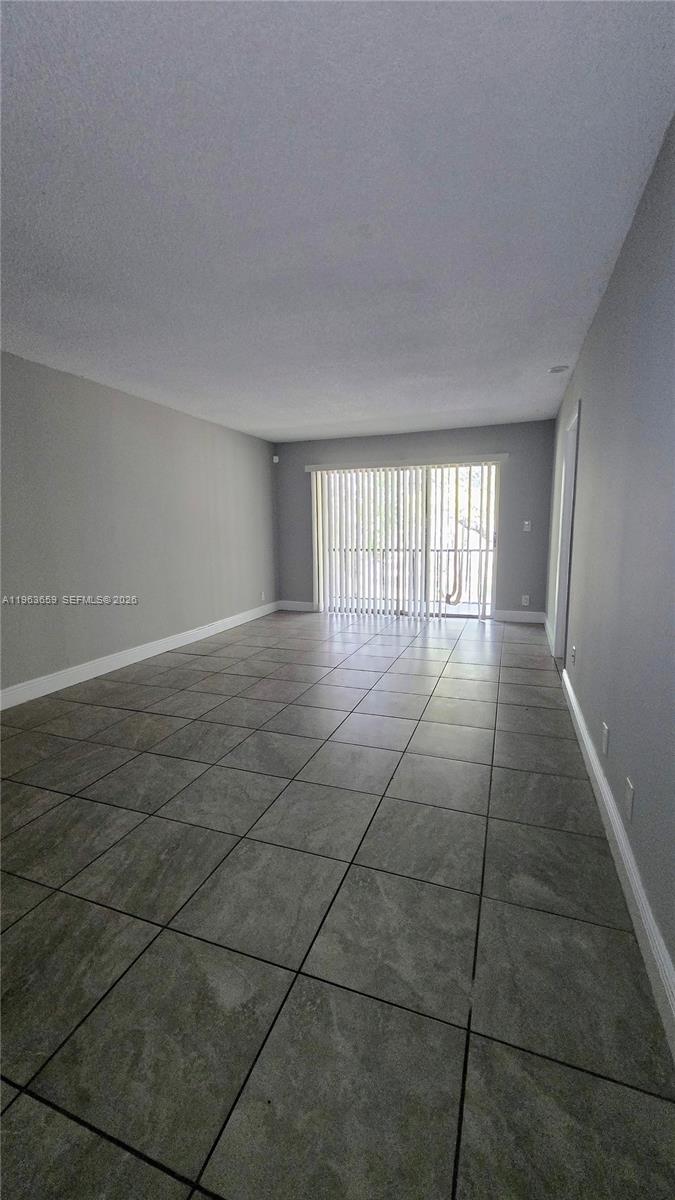 7925 Fairview Drive, Unit 206 Tamarac, FL 33321 - Photo 7 of 21 a view of an empty room with a window